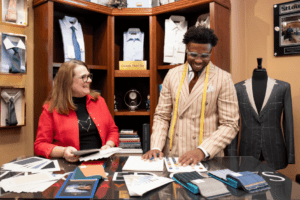 Darryl Tyler, owner of Tailored Gents at Savile Row, and Mary Jo Heydt, Custom Clothier, discussing fabrics.